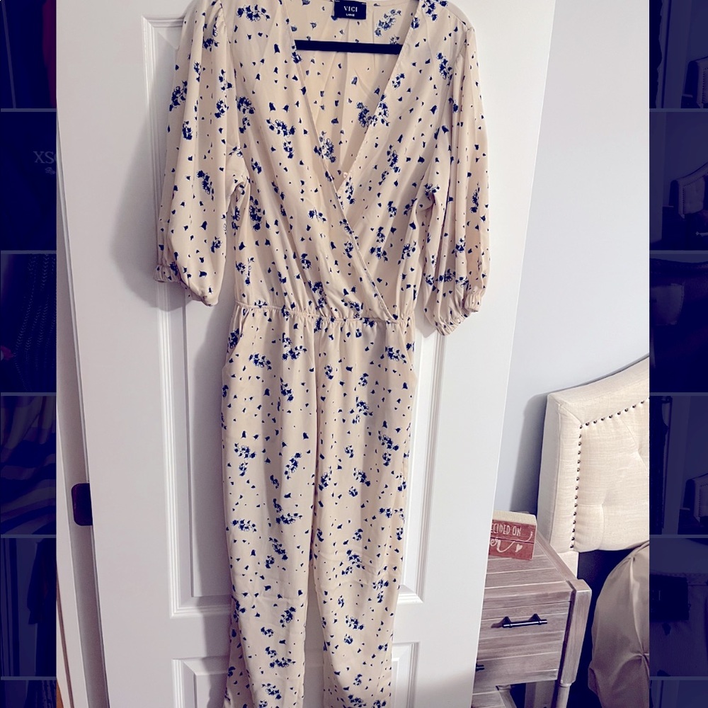 VICI NEW WITHOUT TAGS- off white jumpsuit with royal blue flowers.